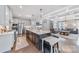 Open-concept kitchen showcasing a large island, stainless appliances, and seamless flow to living areas at 14130 Sunnyhill Grove Rd, Davidson, NC 28036