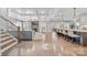 Expansive living room features a fireplace, staircase, kitchen view, and hardwood flooring at 14130 Sunnyhill Grove Rd, Davidson, NC 28036