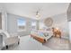 Airy bedroom with neutral decor and a decorative wall hanging for a calming ambiance at 14130 Sunnyhill Grove Rd, Davidson, NC 28036