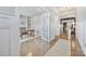 Office area with hardwood floors, built-in shelving, and a view into a living space at 14130 Sunnyhill Grove Rd, Davidson, NC 28036