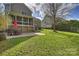 Expansive backyard with a brick patio and steps leading to a charming screened porch above at 142 Mills Ln, Fort Mill, SC 29708