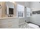 Modern bathroom featuring a glass-enclosed shower, stylish vanity with marble countertop and designer tile floor at 142 Mills Ln, Fort Mill, SC 29708