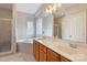 Bright bathroom featuring a double sink vanity, soaking tub with tile surround, and glass enclosed shower at 142 Mills Ln, Fort Mill, SC 29708