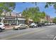 Street view with storefronts, cars parked along the road, and leafy trees overhead at 142 Mills Ln, Fort Mill, SC 29708