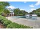 Large community pool covered for the off-season, surrounded by trees and community buildings at 142 Mills Ln, Fort Mill, SC 29708