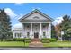 Grand home with large columns, brick steps, a symmetrical facade and well-manicured lawn at 142 Mills Ln, Fort Mill, SC 29708