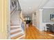 Bright foyer showcasing hardwood floors, a staircase with white railings, and an open floor plan at 142 Mills Ln, Fort Mill, SC 29708