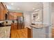 Spacious kitchen boasting stainless steel refrigerator, granite countertops, and hardwood floors at 142 Mills Ln, Fort Mill, SC 29708