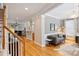 Elegant living room featuring hardwood floors, gray walls, a decorative light fixture, and abundant natural light at 142 Mills Ln, Fort Mill, SC 29708