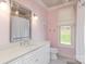 Bathroom featuring white vanity, quartz counters, and decorative mirror at 1426 Merrimont Ave, Kings Mountain, NC 28086