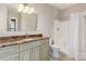 Well lit bathroom featuring a marble counter top with a white shower and white toilet at 1426 Merrimont Ave, Kings Mountain, NC 28086