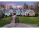 Stunning home with lush landscaping and a grand staircase leading to the welcoming front entrance at 1426 Merrimont Ave, Kings Mountain, NC 28086