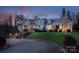 A large home featuring gorgeous landscaping and lighting accents for a luxurious feel at dusk at 1426 Merrimont Ave, Kings Mountain, NC 28086