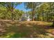 Large, grassy backyard with mature trees provides ample space for outdoor activities at 1513 Fletcher Broome Rd, Monroe, NC 28112