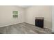 Bedroom featuring wood-look floors, a black dresser, and a large window at 1513 Fletcher Broome Rd, Monroe, NC 28112