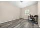 Small bedroom with light walls, wood-look flooring and a desk with chair in corner at 1513 Fletcher Broome Rd, Monroe, NC 28112