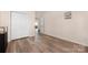 Bedroom featuring wood-look floors, closet, and a view into another room at 1513 Fletcher Broome Rd, Monroe, NC 28112