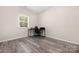 Bedroom showcasing wood-look floors and a large window providing natural light at 1513 Fletcher Broome Rd, Monroe, NC 28112