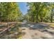 View of the long gravel driveway leading to the home's front exterior and garage at 1513 Fletcher Broome Rd, Monroe, NC 28112