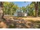 Lovely single-story home with attached garage and covered porch, framed by mature trees and a gravel driveway at 1513 Fletcher Broome Rd, Monroe, NC 28112