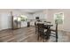 Eat-in kitchen features stainless steel appliances, white cabinets, and wood-look flooring at 1513 Fletcher Broome Rd, Monroe, NC 28112