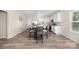 Eat-in kitchen with white cabinets, stainless appliances, wood floors and modern pendant lighting at 1513 Fletcher Broome Rd, Monroe, NC 28112