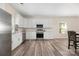 Updated kitchen with stainless steel appliances, white cabinets, and wood-style flooring at 1513 Fletcher Broome Rd, Monroe, NC 28112