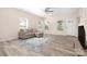 Bright living room with wood-look floors, sofa, and a large rug at 1513 Fletcher Broome Rd, Monroe, NC 28112