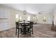 Open floorplan of living room and kitchen, featuring hardwood floors and many windows at 1513 Fletcher Broome Rd, Monroe, NC 28112