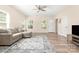 Inviting living room with neutral walls, wood-look floors, and a comfortable gray sectional at 1513 Fletcher Broome Rd, Monroe, NC 28112