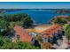 Aerial view of lakefront condos showcasing a private beach, community pool, and boat docks at 17811 Half Moon Ln # C, Cornelius, NC 28031