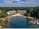 Aerial view of lakefront condos with private beach, boat slips, and community pier at 17811 Half Moon Ln # C, Cornelius, NC 28031
