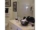 Bathroom featuring white vanity, framed artwork, and mirrored wall at 17811 Half Moon Ln # C, Cornelius, NC 28031
