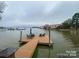 Lakefront dock with seating and umbrella provides stunning water views at 17811 Half Moon Ln # C, Cornelius, NC 28031