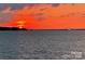 Sailboat glides on lake with orange sunset at 17811 Half Moon Ln # C, Cornelius, NC 28031