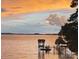 Peaceful lake view with covered dock at dusk at 17811 Half Moon Ln # C, Cornelius, NC 28031