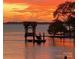 Water view with boathouse and vibrant sunset colors at 17811 Half Moon Ln # C, Cornelius, NC 28031