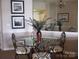 Dining room featuring a mirrored wall, decorative lighting and a glass table with wrought iron chairs at 17811 Half Moon Ln # C, Cornelius, NC 28031