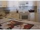 Bright kitchen featuring white cabinets, modern appliances, and a stylish chef-themed placemat at 17811 Half Moon Ln # C, Cornelius, NC 28031