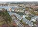 Aerial view showcasing the lakeside community with a pool, lake, and multiple condo buildings at 18832 Nautical Dr # 44, Cornelius, NC 28031