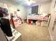 Bright bedroom features carpet, a ceiling fan, loft bed and a play kitchen at 1896 Independence Sq, Kannapolis, NC 28081