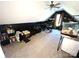 Bonus room with a sloped ceiling, futon sofa, and fish aquarium at 1896 Independence Sq, Kannapolis, NC 28081
