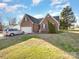 Brick home with a well-maintained lawn and a silver car parked in the driveway at 1896 Independence Sq, Kannapolis, NC 28081
