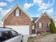 Brick home with an attached garage, a landscaped yard, and a silver car in the driveway at 1896 Independence Sq, Kannapolis, NC 28081