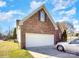 Brick home featuring an attached garage with a silver car partially visible at 1896 Independence Sq, Kannapolis, NC 28081