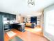 Open-concept living room and kitchen with hardwood floors and modern lighting at 1896 Independence Sq, Kannapolis, NC 28081