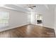 Spacious bedroom featuring a tray ceiling and hardwood floors at 196 Gabriel Dr, Mooresville, NC 28115