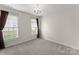 Bright bedroom with two windows and modern chandelier, freshly painted with neutral colors at 196 Gabriel Dr, Mooresville, NC 28115