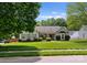 Inviting single-story home with manicured front yard, landscaping, and a bay window at 196 Gabriel Dr, Mooresville, NC 28115
