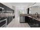 Modern kitchen with stainless steel appliances, granite countertops, and tile backsplash at 196 Gabriel Dr, Mooresville, NC 28115